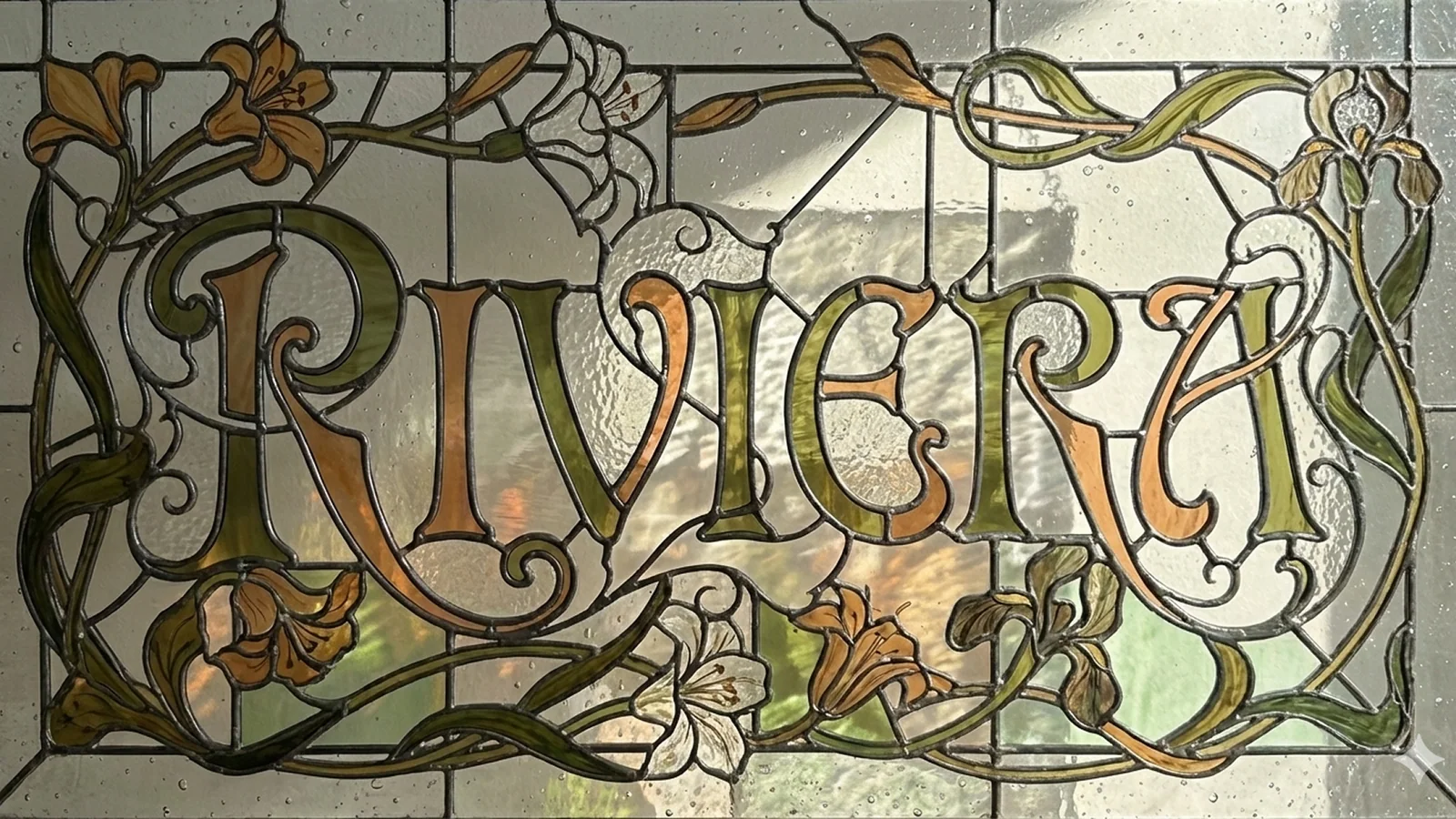 An Art Nouveau stained-glass panel with the word RIVERA formed in ornate lettering